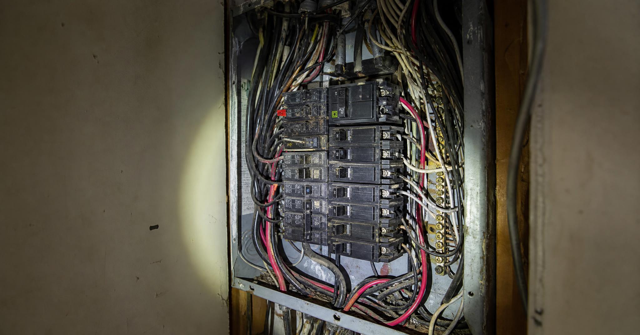 Older crowded residential electrical panel with cramped wiring and a full bus bar.